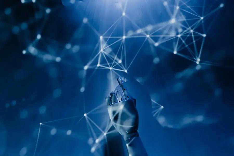 ChatGPT – desafios, riscos e o futuro da inteligência artificial Mão robótica aponta para rede de conexões neurais digitais e pontos de dados luminosos em fundo azul tecnológico.