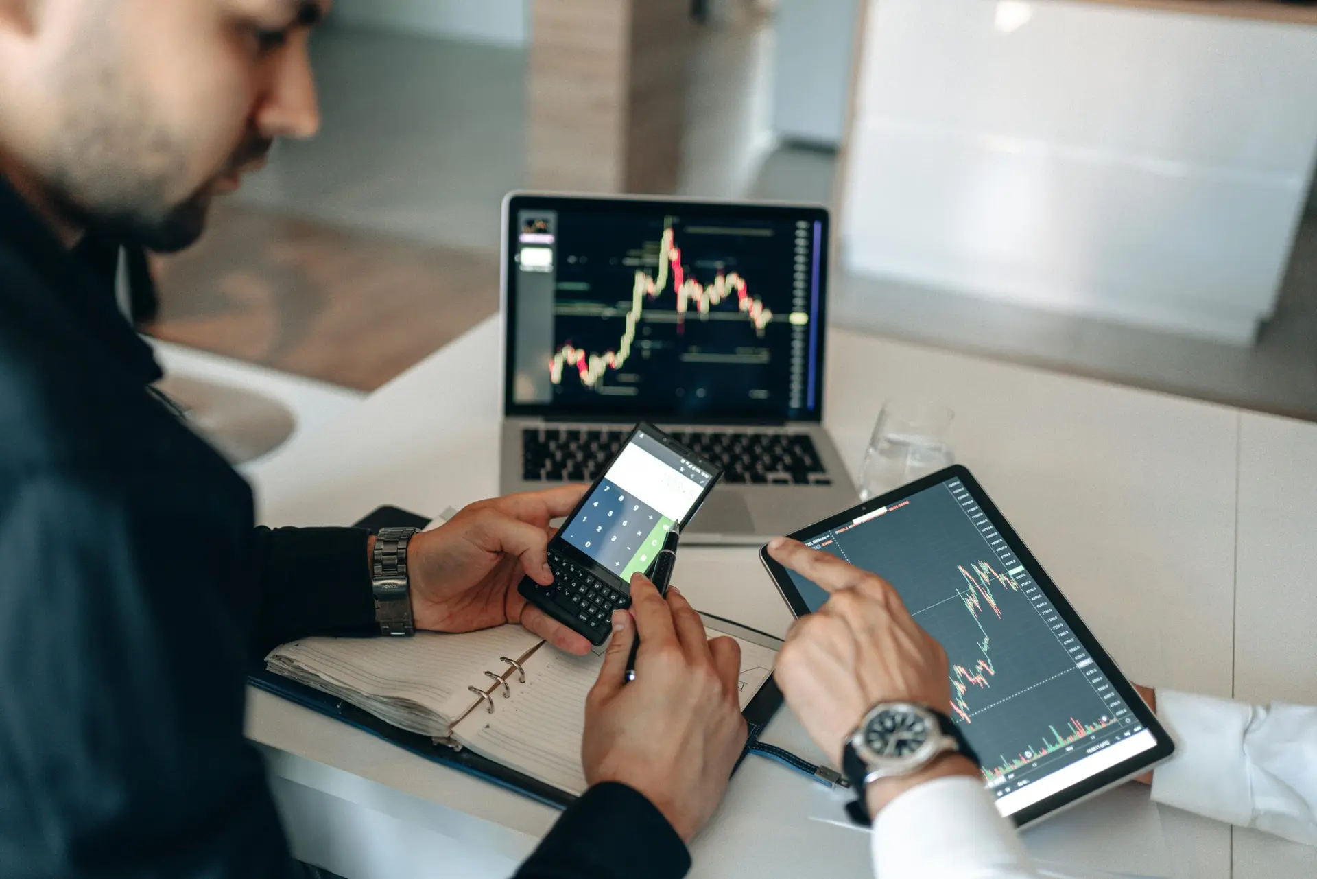 Profissionais analisando dados com IA no setor financeiro em notebook, tablet e smartphone